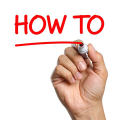 A hand drawing the words "HOW TO" with a red marker on a black background.