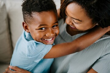 Smiling Black Boy and Mother's Affectionate Embrace
