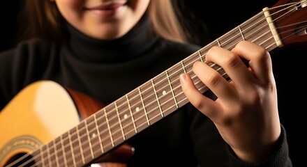 Fototapeta premium Close-up of a Young Person's Hands Playing an Acoustic Guitar with a Smile