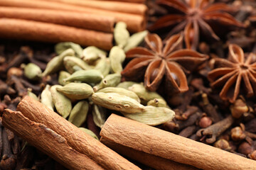 Mulled wine spices. Anise stars, cinnamon sticks, cardamon seeds and cloves as background, closeup