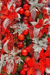 Christmas light decorations with vibrant red and silver ornaments, showcasing intricate details and textures, creating a festive atmosphere with bokeh effects and holiday spirit