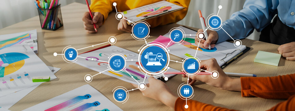 Startup company employee working together, analyzing BI dashboard paper on financial data report and planning strategic marketing for business success in panorama banner. Synergic Amity - Powered by Adobe