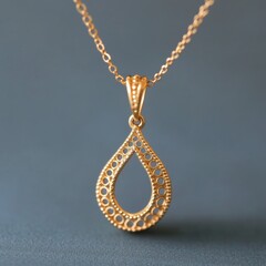Fototapeta premium Elegant Gold Teardrop Pendant Necklace on Gray, Jewelry , Fashion