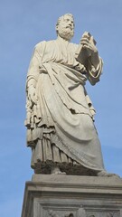 Fototapeta premium Rome, Italy - 12 January 2025. A statue near Castel Sant'Angelo depicts Saint Peter with a book in one hand and keys in the other, dressed in layered robes.