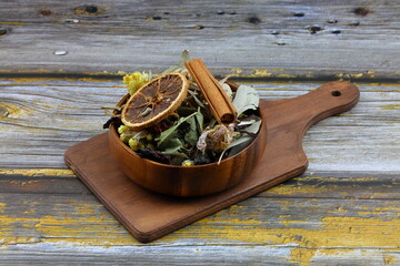 Winter tea for health in cold weather. Flavored with ginger, cinnamon, hibiscus, and orange. Isolated on woodenn background