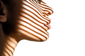 Woman's face in profile is illuminated by a dramatic pattern of horizontal light and shadow stripes, creating an artistic and mysterious high-contrast portrait