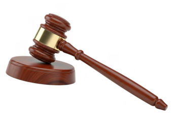 A classic wooden judge s gavel with a polished brass band rests on its sound block against a stark black background symbolizing justice and legal proceedings