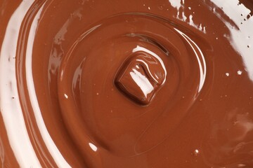 Tasty melted chocolate and piece as background, top view
