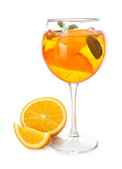 Glass of refreshing spritzer cocktail with mint and orange slices isolated on white