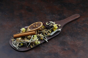 Winter tea for health in cold weather. Flavored with ginger, cinnamon, hibiscus, and orange. Isolated on woodenn background