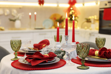 Festive table setting with Christmas decor in kitchen, closeup. Interior design