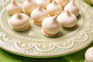 Sweet meringue, a Brazilian sweet called suspiro made with egg whites and sugar, positioned on rustic fabric and accessories, selective focus.