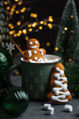 Gingerbread Cookie Man into Christmas Mug with Marshmallows and Festive Decor