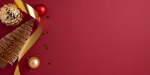 Golden Christmas Tree with Gold Ribbons and Ornaments on Red Background
