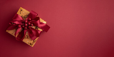 Gold Wrapped Christmas Gifts with Red Ribbons on Red Background