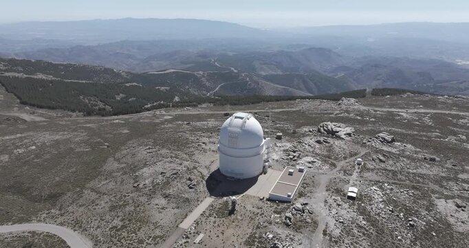 Aerial drone shot of Calar Alto Observatory telescope in the Sierra de Los Filabres mountain range in Almeria, Andalusia, Spain. Largest astronomical observatory in Europe. Sunny, clear blue sky 