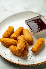 Enjoy a delightful spread featuring crunchy golden bites paired with a rich, sweet dipping sauce. Perfect for sharing during a warm gathering among friends
