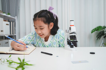 Elementary School Girl Taking Notes Science Experiment Microscope STEM Research