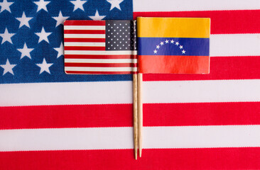 flags of the USA and Venezuela on the background of the flag of the USA