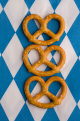 small pretzels on the background of the classic blue and white cage of the German festival