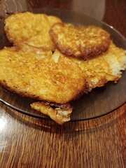 Golden brown potato pancakes, also known as draniki or latkes, prepared as a homemade comfort food dish, served warm on a plate for breakfast or a hearty meal