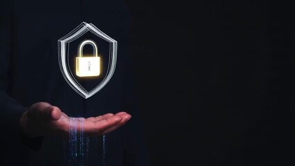 Person holds glowing shield symbolizing cybersecurity, representing importance of protecting digital information against threats and vulnerabilities in our interconnected world. Padlock icon. 4K video - Powered by Adobe