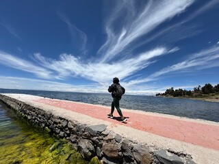 A woman running on jetty nearby the Titicaca-lake. 