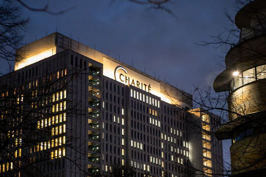 BERLIN, GERMANY - 26. November 2025: Charite hospital building at night. Illuminated exterior of the main building named "Bettenhaus". High rise house in the mitte district.