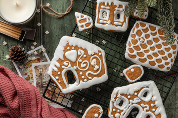 Homemade gingerbread house. Pieces for building a gingerbread house decorated with sugar icing on festive wooden table. Christmas Holiday tradition, top view