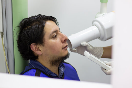 Man receiving dental x-ray for oral health check-up - Powered by Adobe