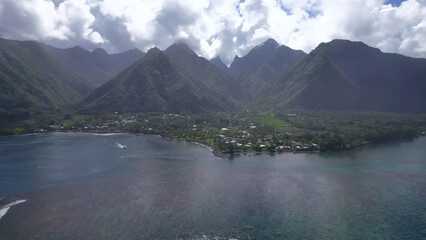 Luxury resort photo of French Polynesia tropical 
paradise island Fakarava with palm trees. Photography
with ocean, mountain, sky with clouds.