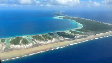 Luxury resort photo of French Polynesia tropical 
paradise islands Fakarava with coral reef. 
Aerial perspective photography with azure ocean, 
sky with clouds on horizon. Pacific Ocean.