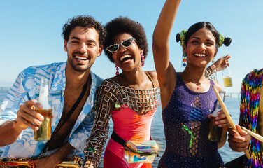 Carnival friends celebrate on the beach