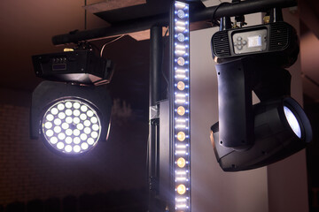 Rehearsal room lighting equipment, Stage lighting with various fixtures and effects, Comprehensive stage illumination system including LED strips and moving head fixtures