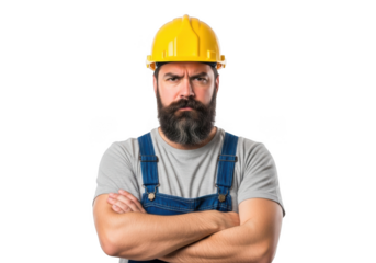 Serious bearded construction worker wearing yellow hard hat and blue overalls standing confidently with arms crossed isolated on transparent background