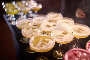 Elegant smoky cocktail, Craft bartenders create visually stunning smoky drinks ambiance, Nightlife scene features misted cocktails with dramatic lighting and sensory effects