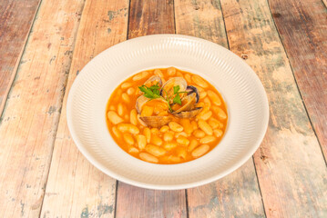 Homemade fabada served straight from the pot to the table, with a wooden spoon, just like in Asturian homes