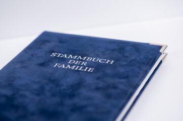 Family record book with blue cover on a table