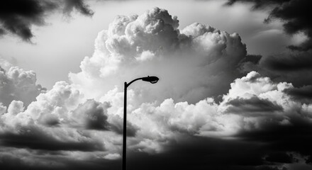 Dramatic black and white cloudscape with streetlight silhouette