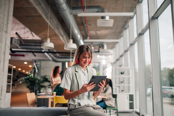Businesswoman using digital tablet in modern office