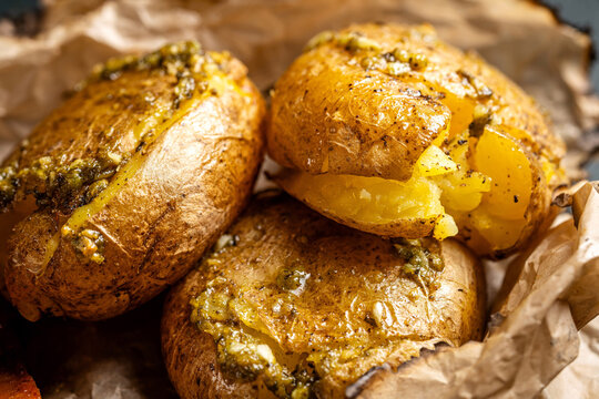 Baked potatoes with herb butter closeup