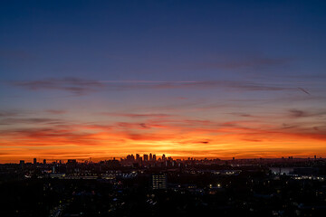 Naklejka premium Epic sunset over Canary Wharf in London as seen from Abbey Wood.