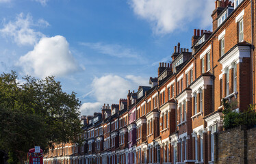 Central London real estate - a row of terraced houses against summer blue sky. © Roksana Tomasiak