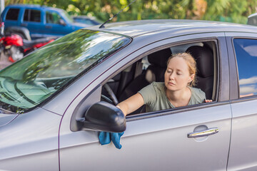 Woman cleaning her car, organizing seats and removing clutter to keep the vehicle tidy. Auto care, cleanliness and everyday routine concept, representing responsibility, order and modern lifestyle
