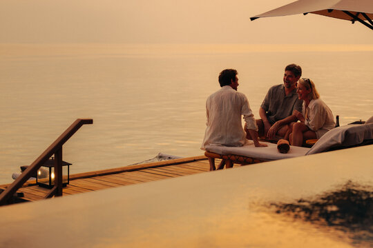 Serene family moment: Togetherness and relaxation during a beautiful sunset - Powered by Adobe