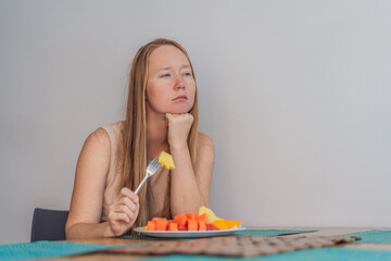 Woman enjoying a peaceful breakfast at the table in a bright home interior, starting her morning with calm energy. Healthy lifestyle, morning routine and wellbeing concept, representing self-care