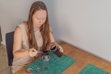 Woman enjoying a peaceful breakfast at the table in a bright home interior, starting her morning with calm energy. Healthy lifestyle, morning routine and wellbeing concept, representing self-care