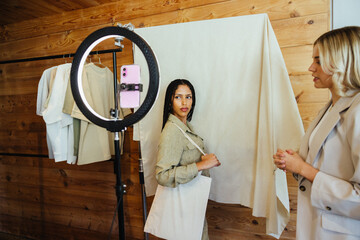 Women collaborating in a cozy studio with modern setup and stylish backdrop