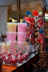 Candy apples, lollipops, and cotton candy at market stall