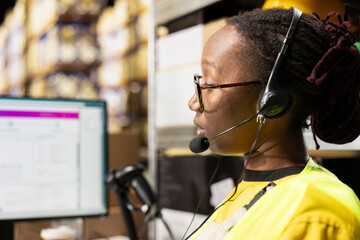 Close up of call center staff assisting clients in a distribution center, handling inventory and...
